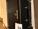 a black amp sitting on top of a shelf next to a wall