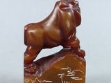 a small figurine of a lion on top of a rock