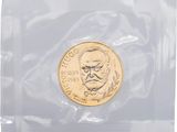 a close up of a coin in a plastic bag on a white surface