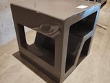 a microwave oven sitting on the floor next to a table