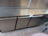 a stainless steel counter with a sliding door on it