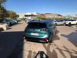 a green car parked in a parking lot next to other cars