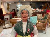 a figurine of a woman holding a basket in a store