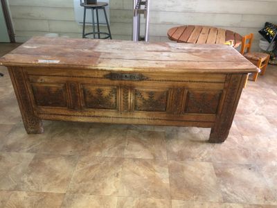 a wooden chest on the floor in a room