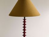 an image of a red table lamp with a yellow shade on it