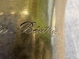a silver container with a name on it on a table