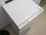 a white refrigerator sitting in a kitchen next to a stove
