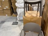 a stack of boxes and a chair in a warehouse