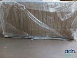 a couch that is wrapped in plastic and sitting on the floor