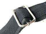 a black belt with a metal buckle on a white surface