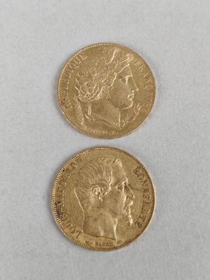 two gold coins, one of which has a woman ' s head and one of which is a man '