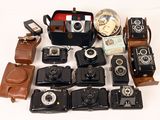 a lot of old cameras and a case on the table