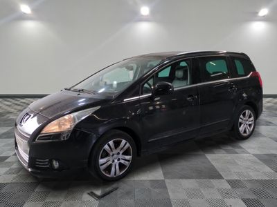 la photo d'un monospace noir garé dans un garage