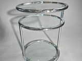 two tiered glass side table with a glass top on a white surface