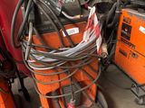several welding equipment are stacked on top of each other in a garage