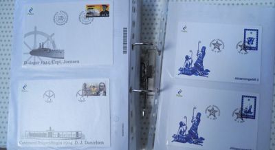 four envelopes with stamps and a pen on top of them