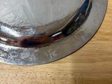 a silver hat sitting on top of a wooden table