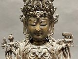 an image of a statue of a person sitting on a chair