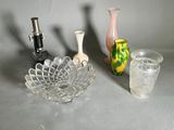 three vases and a glass sitting on a table
