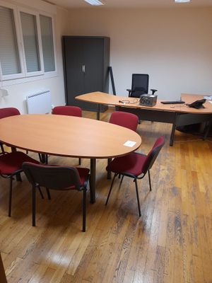 a room with a table and chairs in it