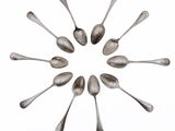 several spoons are arranged in a circle on a white surface