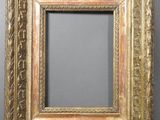 an antique gold frame with a decorative pattern on the edges