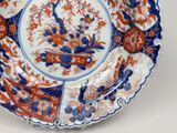 a blue and orange plate with a flower design on it