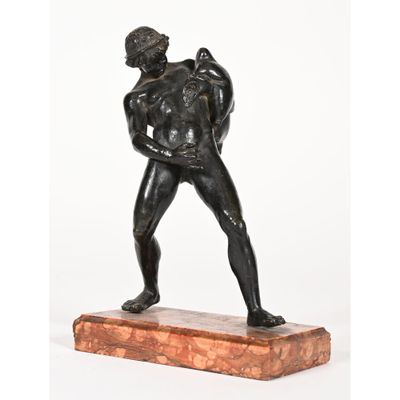 a bronze statue of a man holding a bag on a marble base