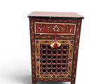 an image of a small wooden cabinet with a red and gold design