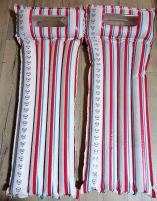 une paire de coussins rayés de rouge, de blanc et de bleu posés sur un parquet