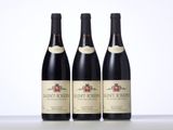 three bottles of wine sit on a table in front of a white background