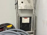 a hose that is attached to the wall next to a water heater
