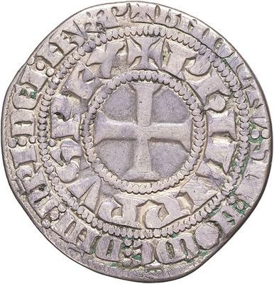 a close up of a coin with a cross on it