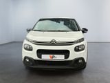 a white citrole parked in a room with a black floor