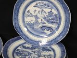 several blue and white plates are stacked on top of each other