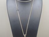 a close up of a necklace on a mannequin with a chain