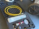 a box with a hose and a gas can in it