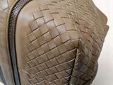 a brown bag with a zipper on it sitting on a table
