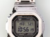 a close up of a digital watch on a white surface