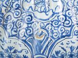 a blue and white vase sitting on a table