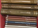 many books stacked on top of each other in a red box