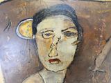 an image of a painting of a woman ' s face on a wall