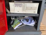 a red cabinet that has a bunch of electronic equipment on it