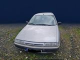 an image of a car that is parked in a field