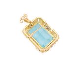 a close up of a gold and blue stone pendant on a white background
