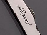 a knife with a writing on it sitting on a table