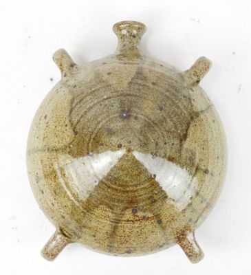a picture of a brown and white vase on a white surface