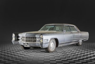 an image of a silver car on a black and white checkered floor