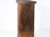 an old wooden stool sitting on top of a white surface