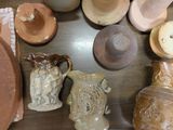 many different types of pottery displayed on the table
